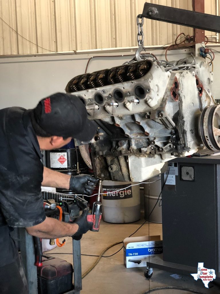 auto mechanic working on motor