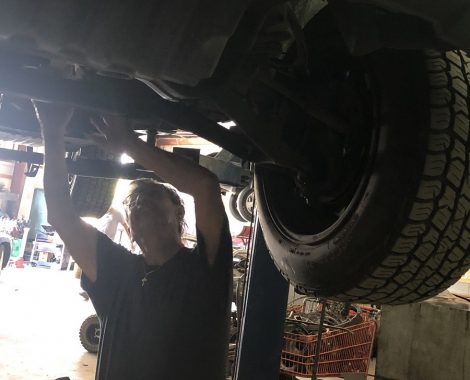 mechanic working under auto